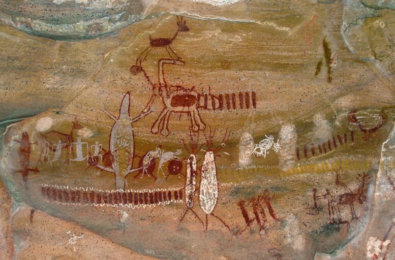 Pintura rupestre encontrada na Serra da Capivara. Há alguns riscos desenhados na vertical ao lado de animais diversos. 