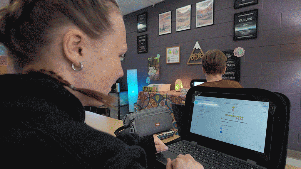 a student celebrates after getting a correct answer on Khan Academy, confetti blasts on the screen of their laptop